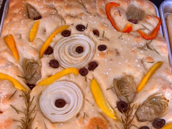 close up of focaccia bread with peppers and onions