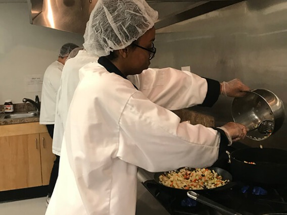 Italian students cooking at the stove