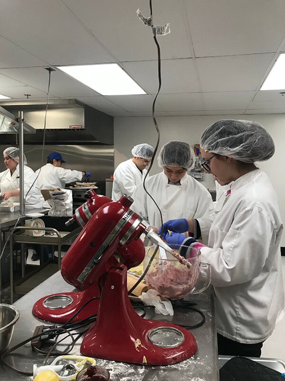 Italian students cooking in kitchen